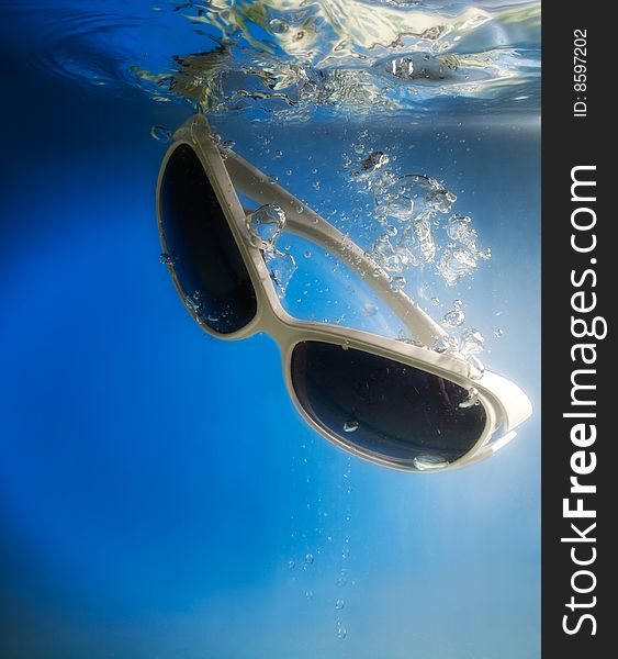 Glasses in water on a blue background