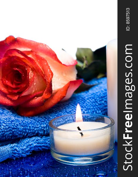 Candle with flower on blue background