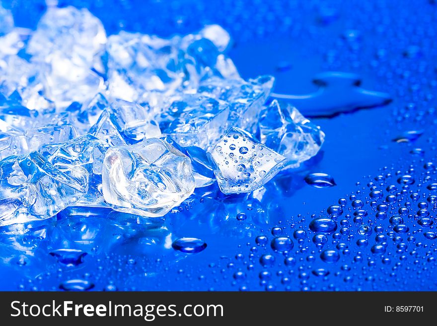 Close-up of ice cubes on blue