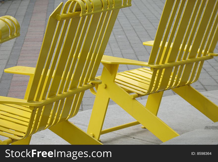 Yellow metal chairs in a park. Yellow metal chairs in a park