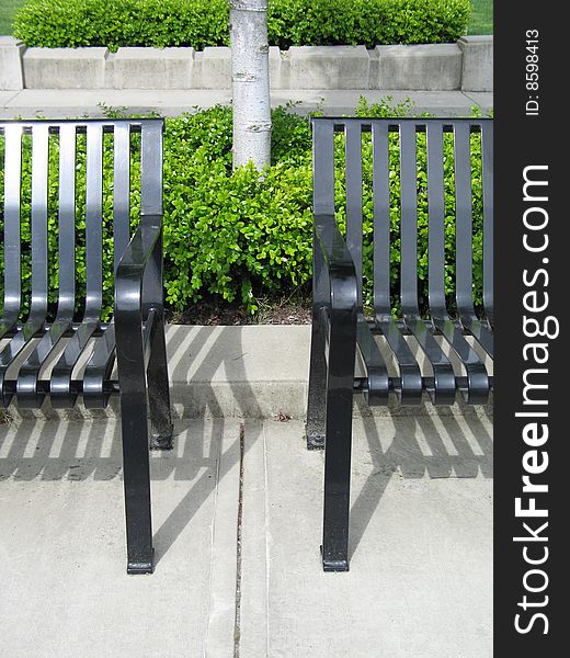 Black metal bench in a park. Black metal bench in a park