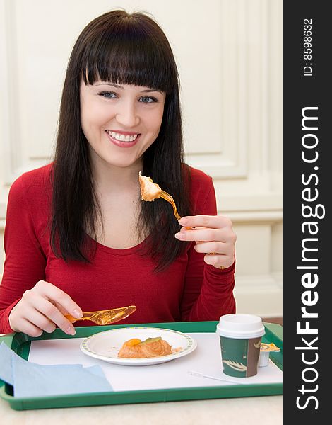 Portrait of young smiling woman with cake