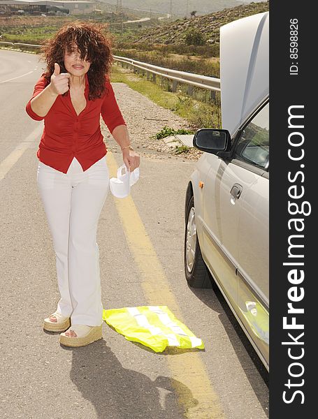 Despaired Elderly Woman Near Her Broken Down Car at the Side of the Road. Despaired Elderly Woman Near Her Broken Down Car at the Side of the Road.