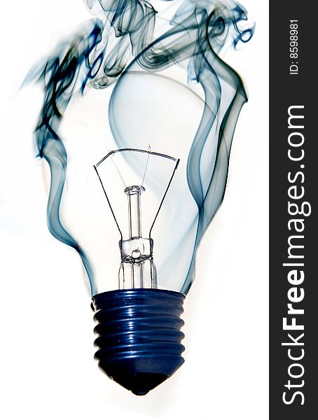 Burning light bulb with blue smoke