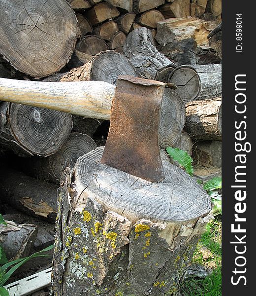 Rusty axe on a log
