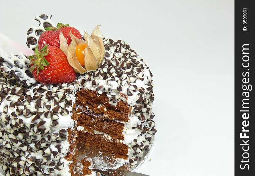 Cut cake with chocolate chips and berries (left)