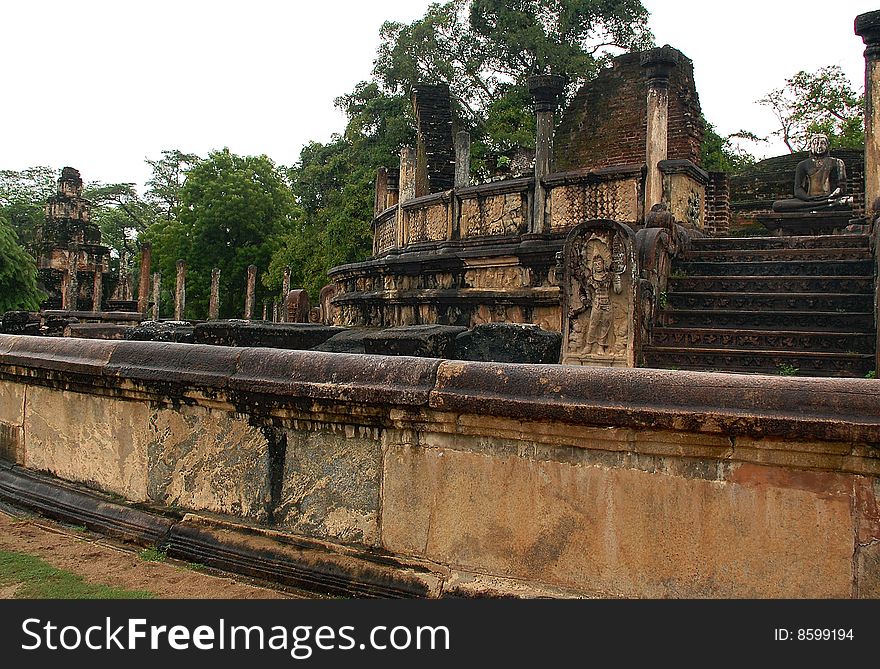 Ruins of Vatadage temple where four seated Buddha statues are located. To the left of it in the backgtound you can see Satmahal Prasada. Ruins of Vatadage temple where four seated Buddha statues are located. To the left of it in the backgtound you can see Satmahal Prasada.