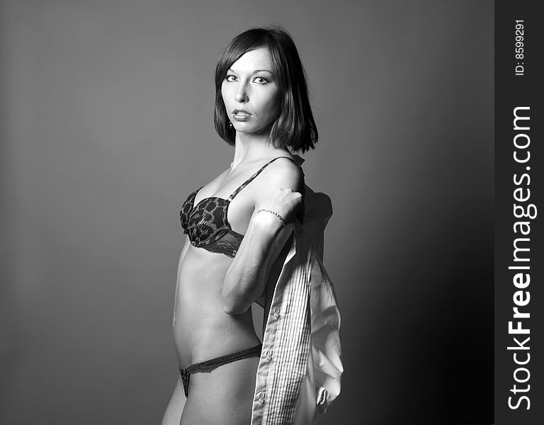 Seductive woman undressing in studio