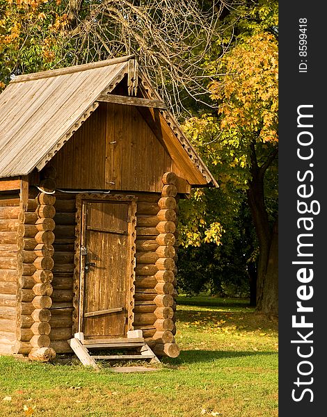 A small log house in an autumn park