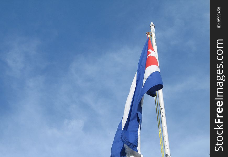 Cuban flag in the blue sky