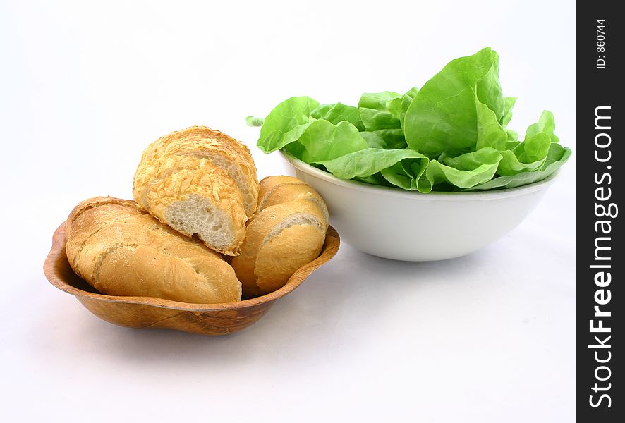 Tiny sliced breadroll and lettuce - primary sandwich ingredients. Tiny sliced breadroll and lettuce - primary sandwich ingredients