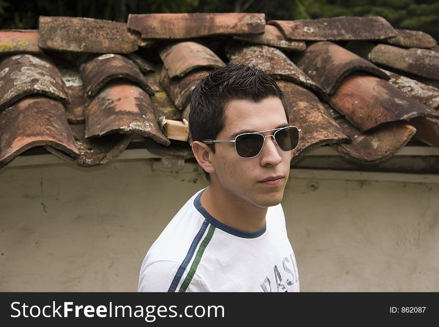 Young male modeling in and old wall