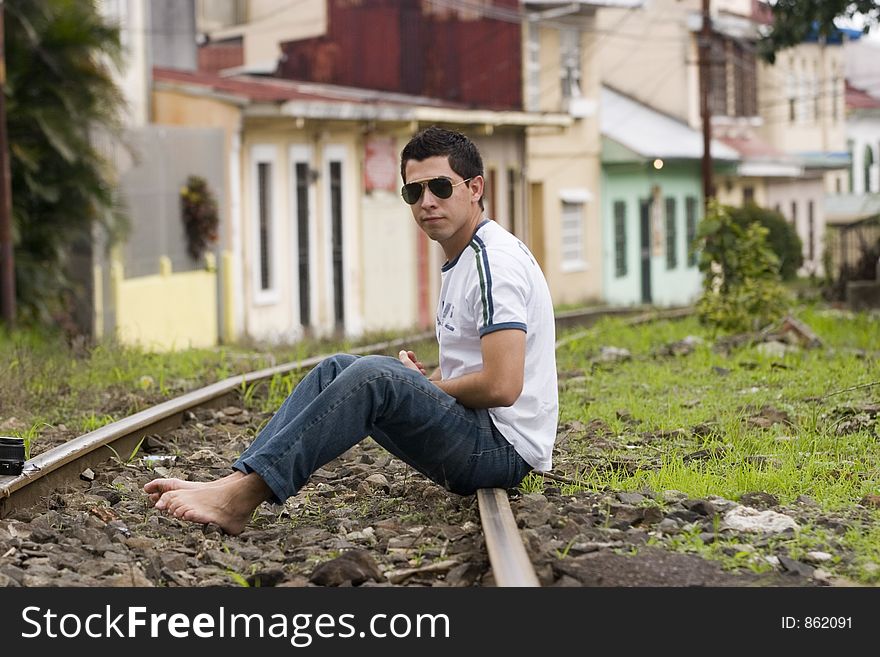 Young male model in the rails of the train