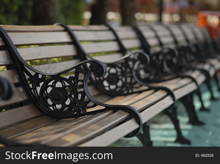 This row of bench was taken in an amusement park while resting. This row of bench was taken in an amusement park while resting.