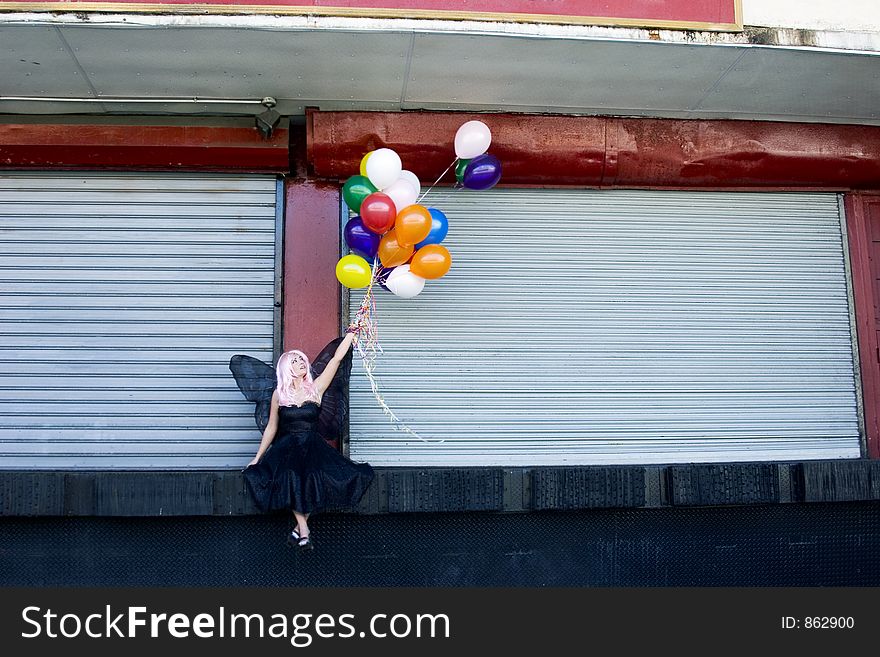 Fairy with balloons in an urban setting