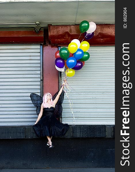 Fairy with balloons in an urban setting