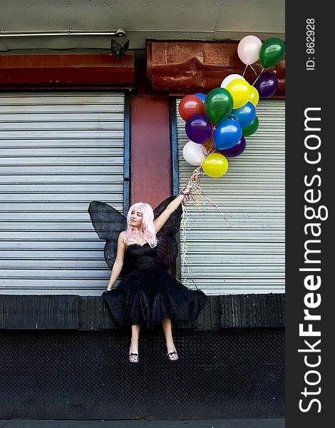 Fairy with balloons in an urban setting