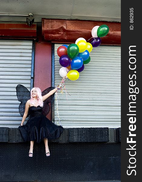 Fairy with balloons in an urban setting