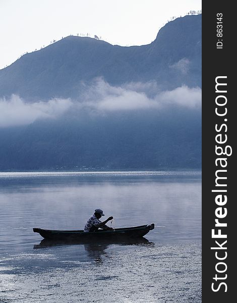 Fisherman working in a misty morning. Fisherman working in a misty morning