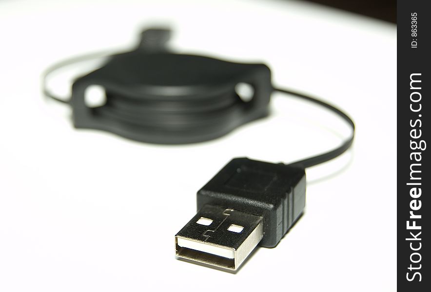 Black USB Cable over white background Shallow Depth of field