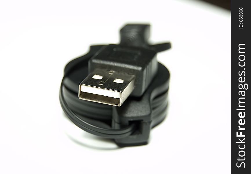 Black USB Cable over white background Shallow Depth of field
