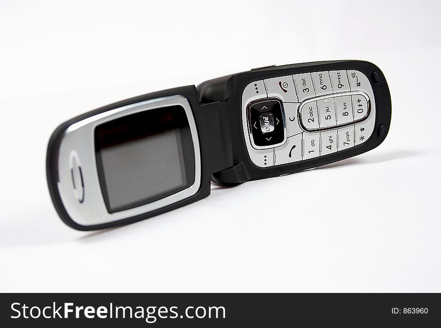 Black cell phone on white background with photo camera and grey buttons. Black cell phone on white background with photo camera and grey buttons