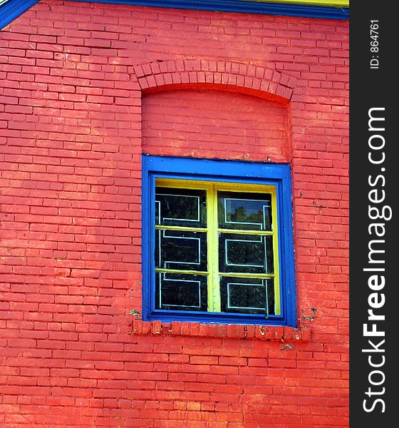 A colorful building and window create a nice graphic background. A colorful building and window create a nice graphic background.