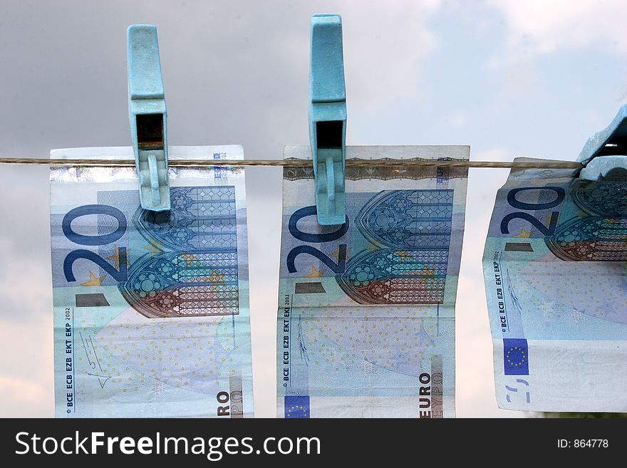 Twenty euros in  hanging on a clothes line drying