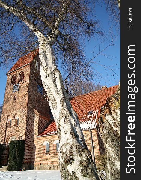 Small church in denmark in a forest in the winter