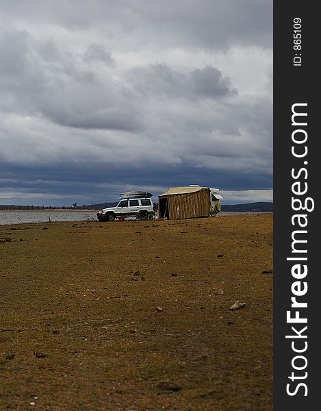 Setting up a camp near a lake. Setting up a camp near a lake