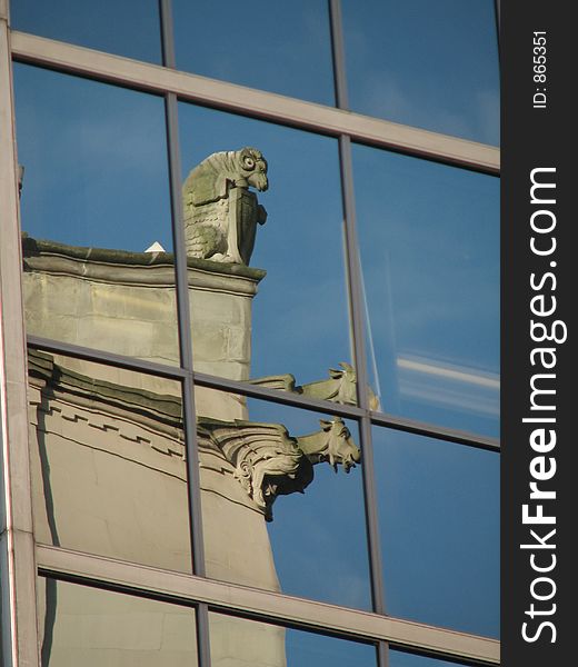 Caught in the reflection of a neighbouring office tower, the ever vigilant gargoyles of the Hotel Vancouver keep watch. Caught in the reflection of a neighbouring office tower, the ever vigilant gargoyles of the Hotel Vancouver keep watch