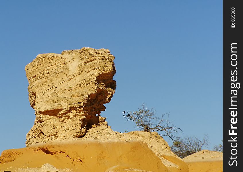 A rock formation in a desert. A rock formation in a desert