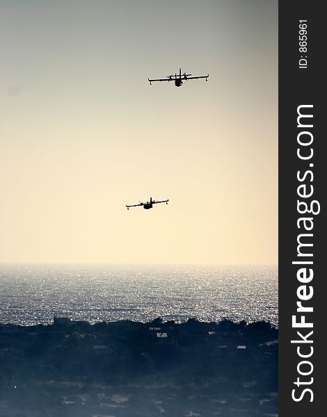 Fire in the corsican mountains: a plane is throwing water on the fire. Fire in the corsican mountains: a plane is throwing water on the fire