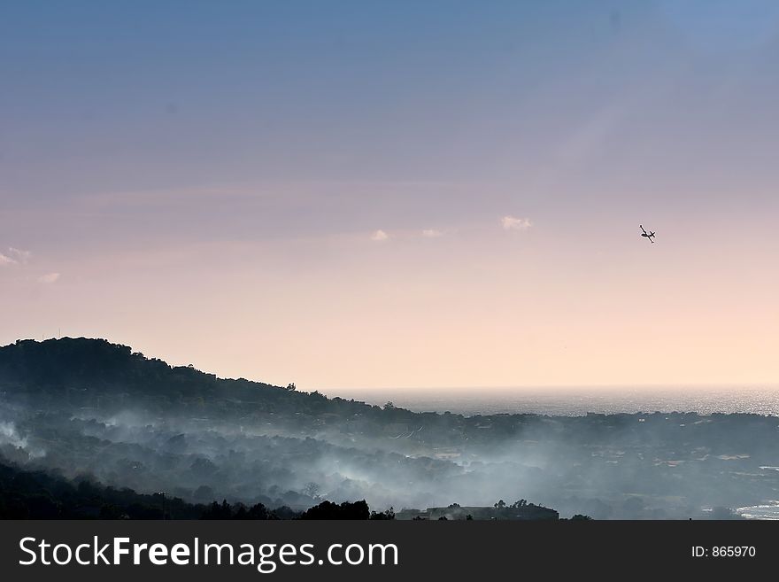 Fire in the corsican mountains: a plane that are throwing water on the fire. Fire in the corsican mountains: a plane that are throwing water on the fire