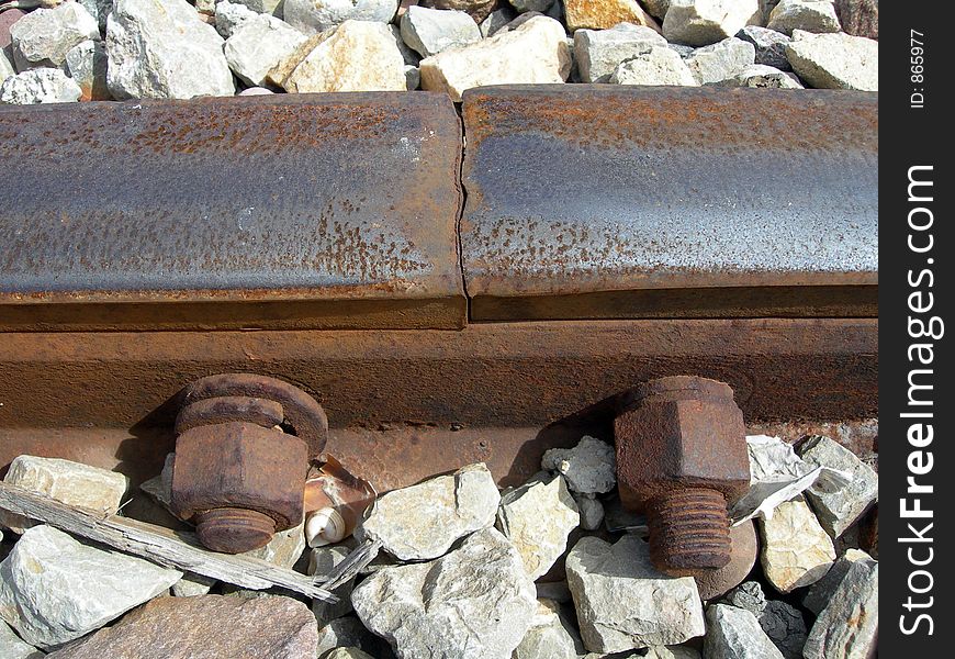 Oxidized union of train tracks with two screws