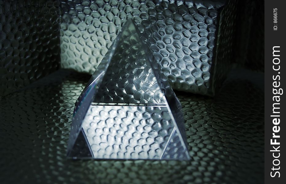 Pyramid of glass with metal background. Pyramid of glass with metal background