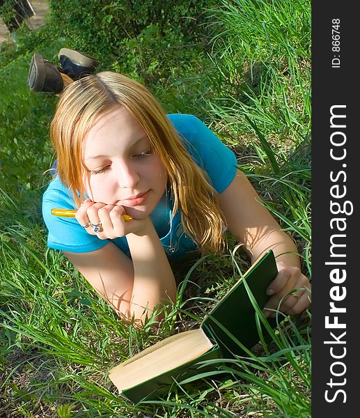 Girl Reads The Book Lying Down.