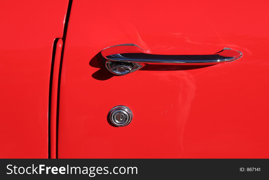 Door handle and lock of a red '57 Chevy. Door handle and lock of a red '57 Chevy