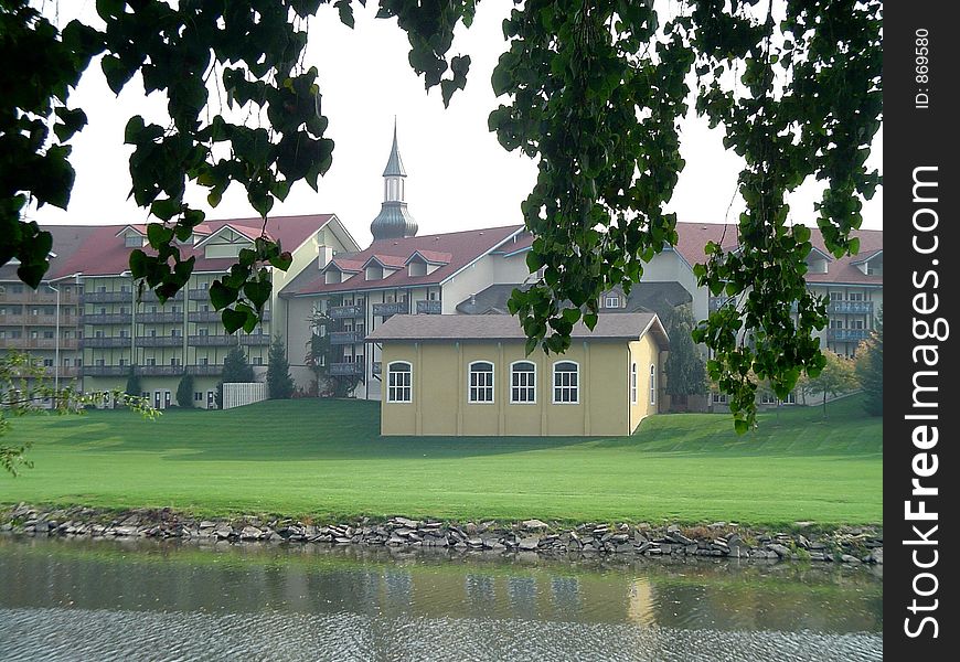 This is a picture of the Frankenmuth Bavarian Motor Lodge taken from across the Cass River in the early summer.