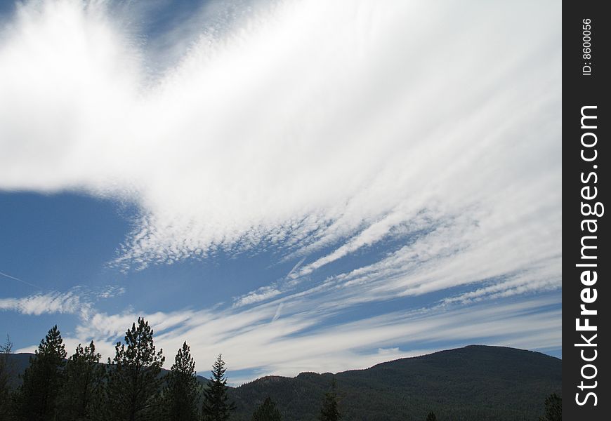 White moving clouds in the blue sky