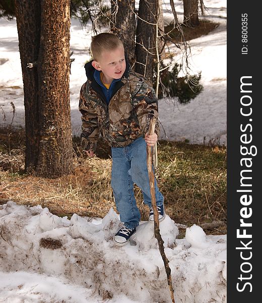 A color image of a young boy standing on a snow bank. A color image of a young boy standing on a snow bank.