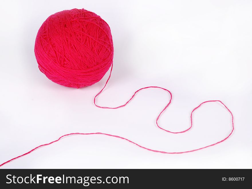 Red threads and clew  isolated on a white background. Red threads and clew  isolated on a white background