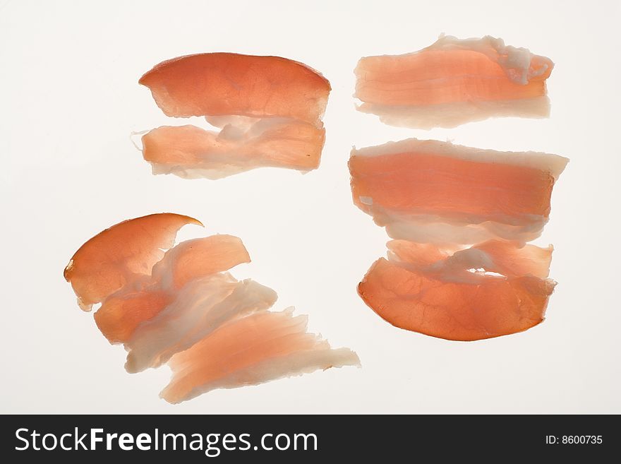 Slides of bacon on white background