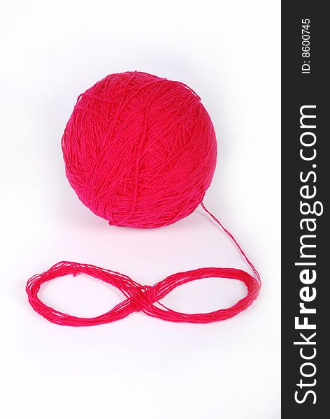 Red threads and clew  isolated on a white background. Red threads and clew  isolated on a white background