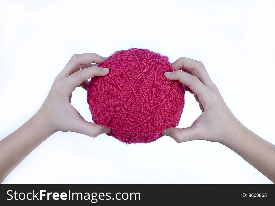 Red threads clew in hands isolated on a white background