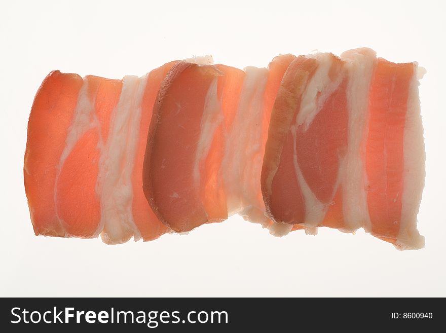 Slides of bacon on white background