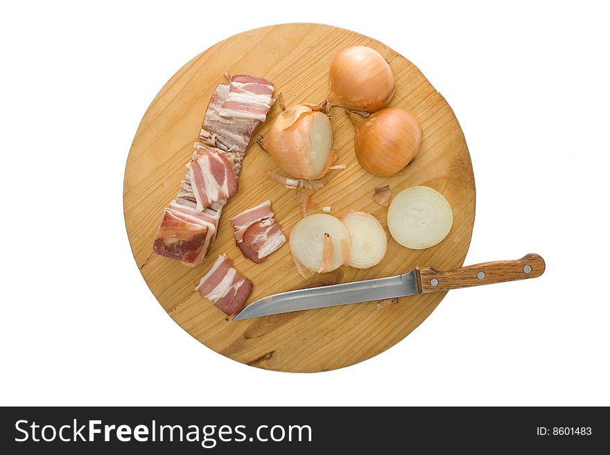 Bacon, onion and knife on kitchen  chopping board. Bacon, onion and knife on kitchen  chopping board