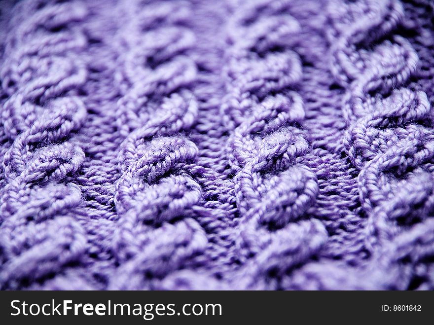 Knitted texture of violet color, pigtail