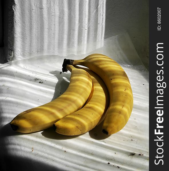 Bananas and stripped shadows from window