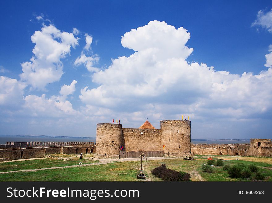 Old stone fortress siege against blue sky